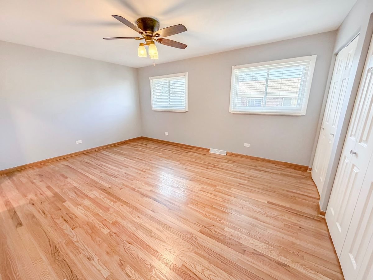 Finished bedroom with refinished hardwood floors and fresh paint