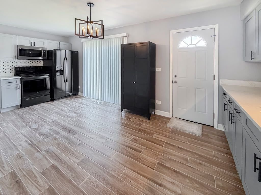 Finished open kitchen with new wood-look tile floor